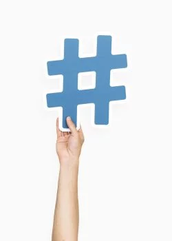 Hand holding hashtag symbol Hand holding hashtag symbol